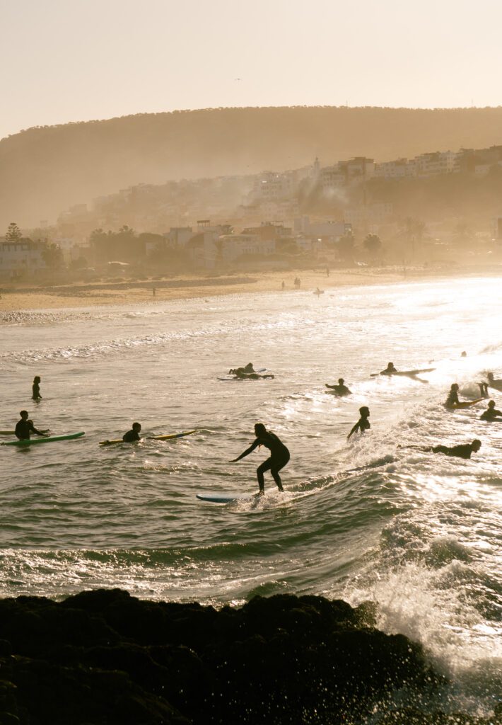 Instructor coaching intermediate surfer in lineup Morocco