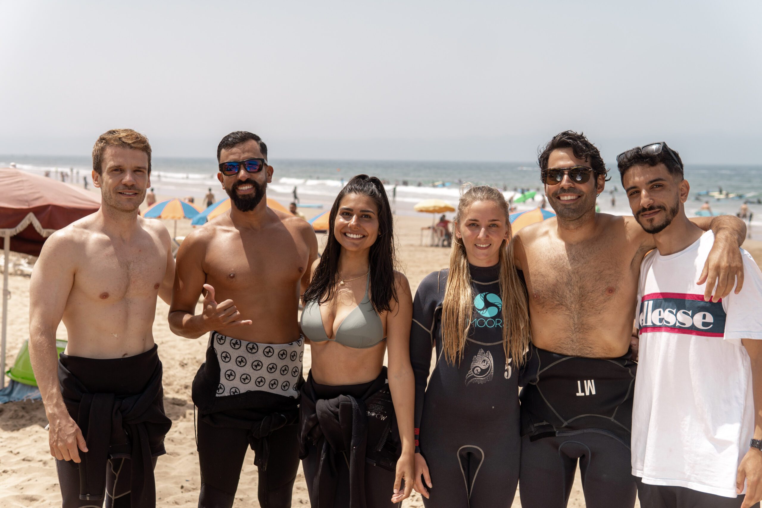 Solo female surfer walking on beach Tamraght Morocco sunset